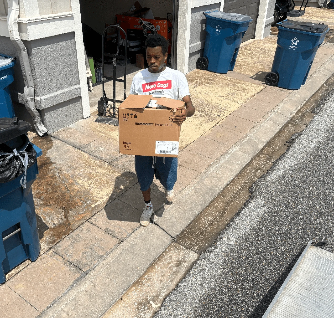 BRS crew member carrying a box beside a moving truck